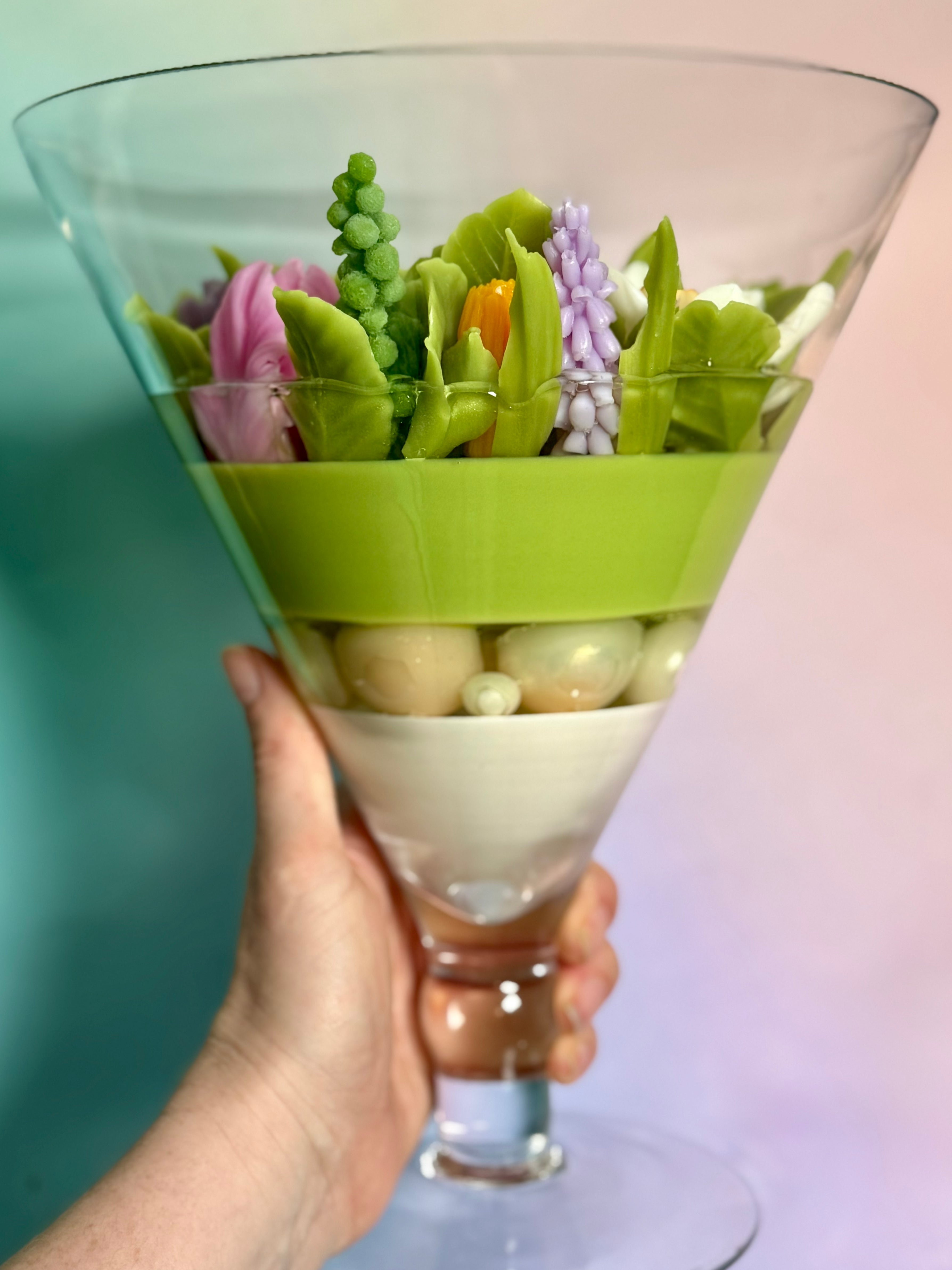 The Eternal Bloom statement floral piece being held to show its massive scale for a landmark birthday gift.