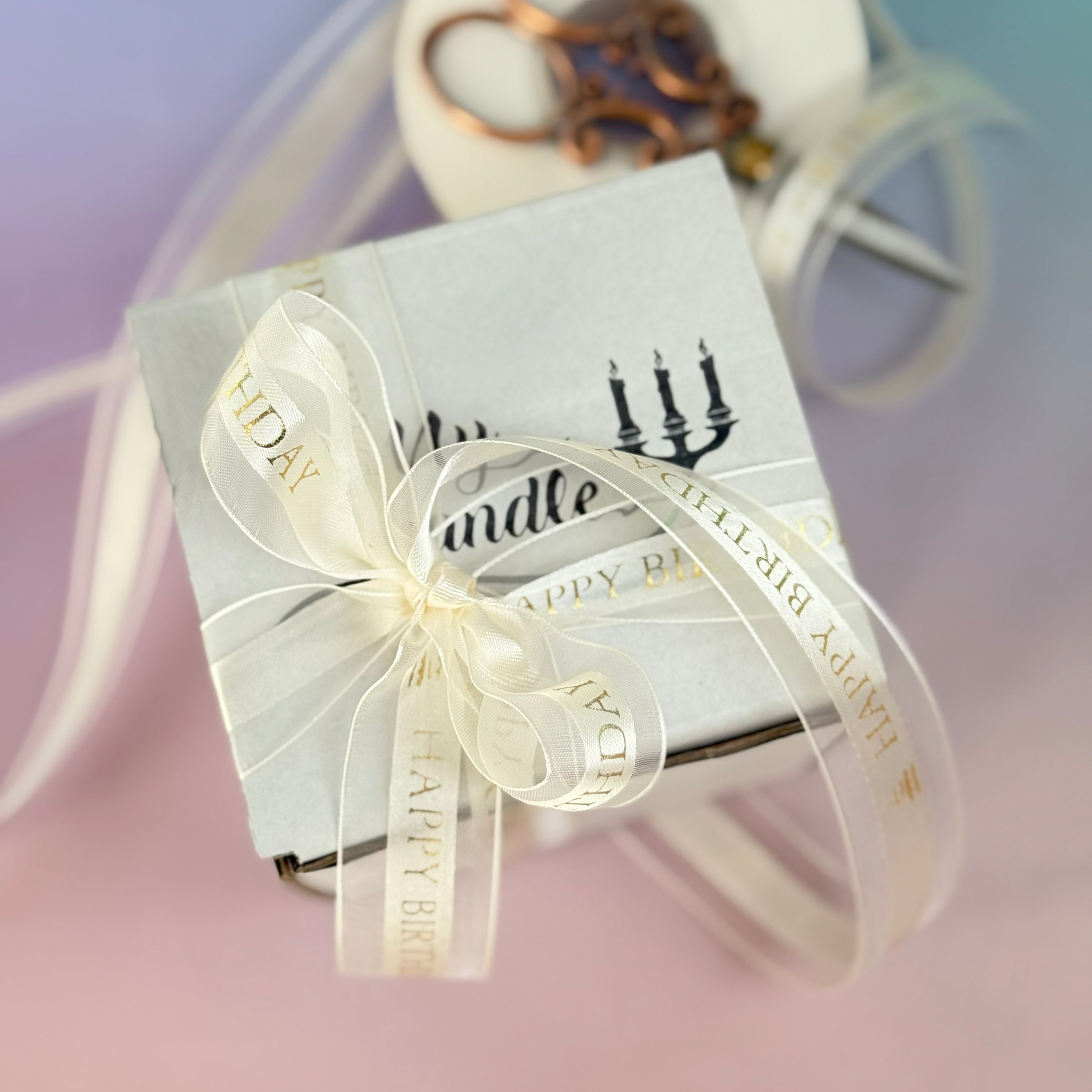 Luxury gift-wrapped personalised soy wax candle with a white branded ribbon, ready for an anniversary or special occasion.