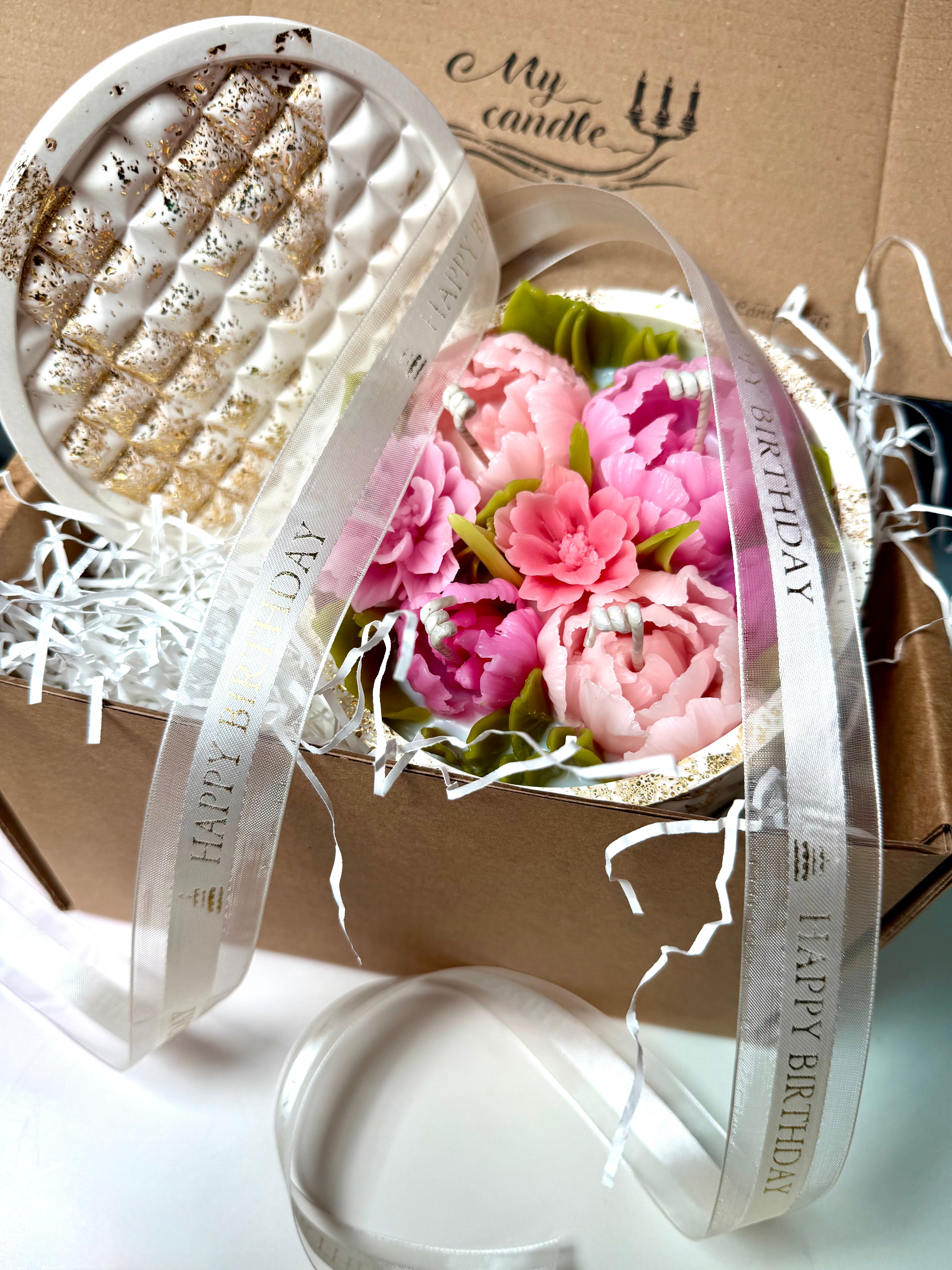 Large floral candle unboxing experience with eco-friendly shredded paper