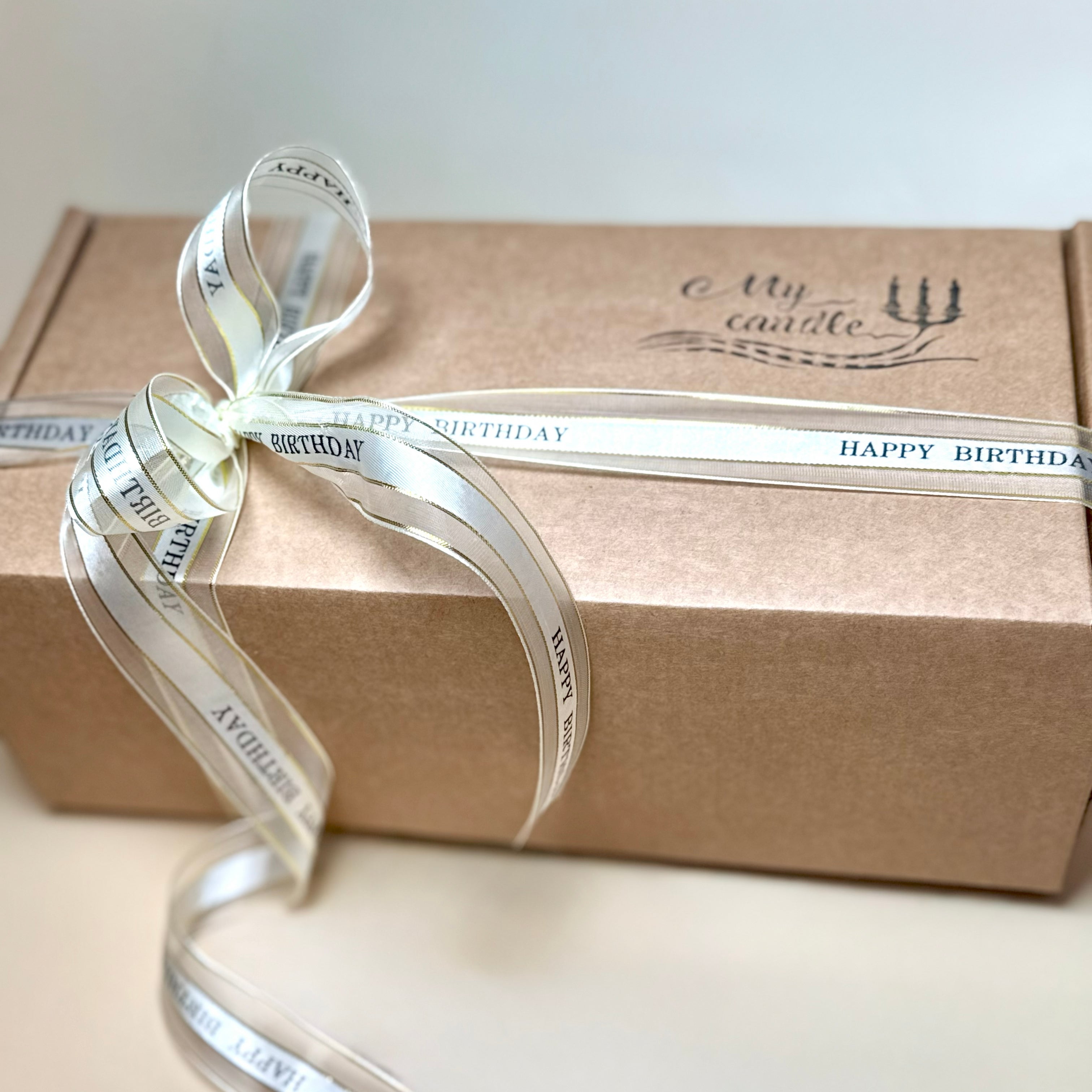 Bespoke candle gift set in a premium craft box with a "Happy Birthday" ribbon, perfect for a luxury birthday gift or anniversary.