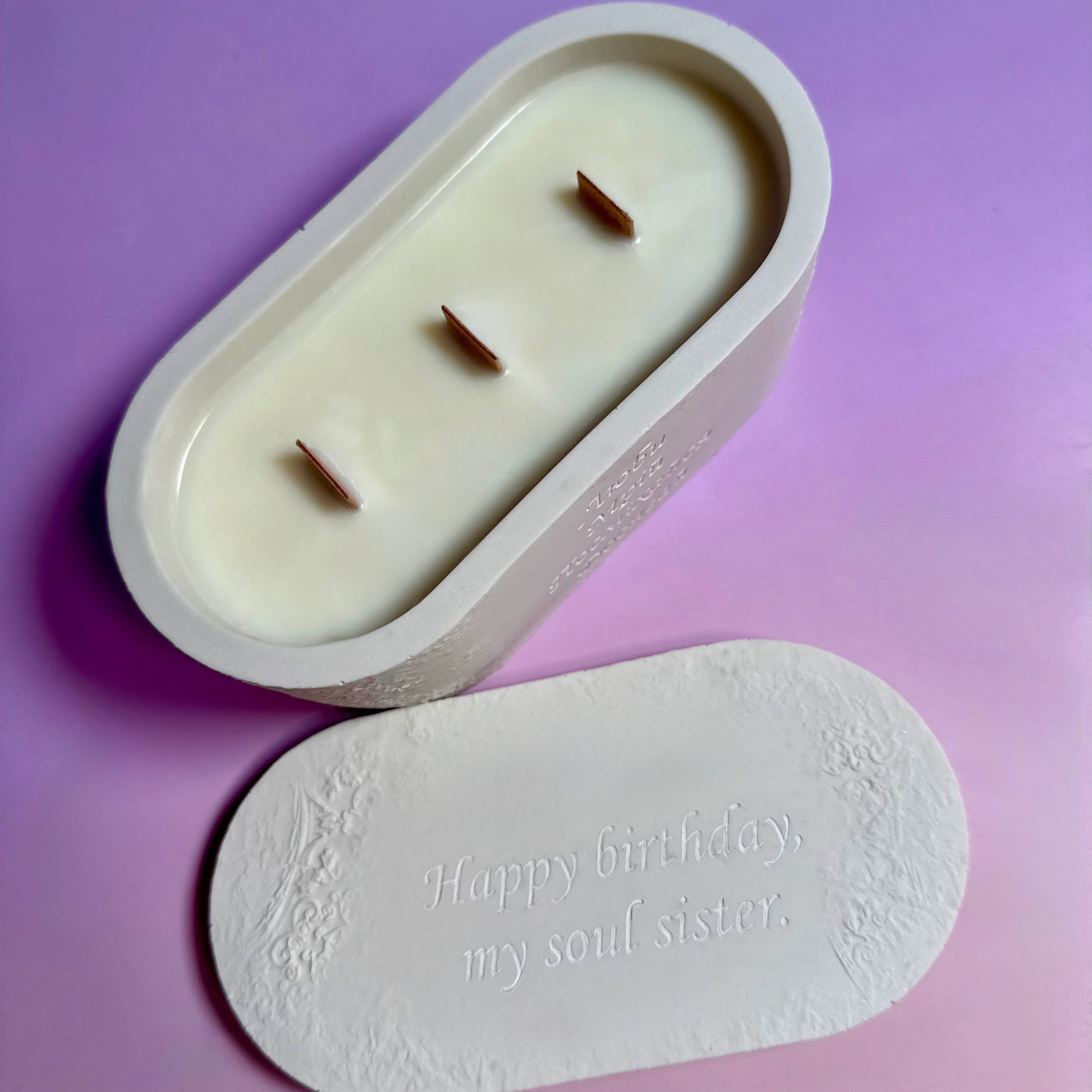 Triple wooden wick candle in a white Jesmonite pot with a personalised engraving on the lid saying "Happy birthday".
