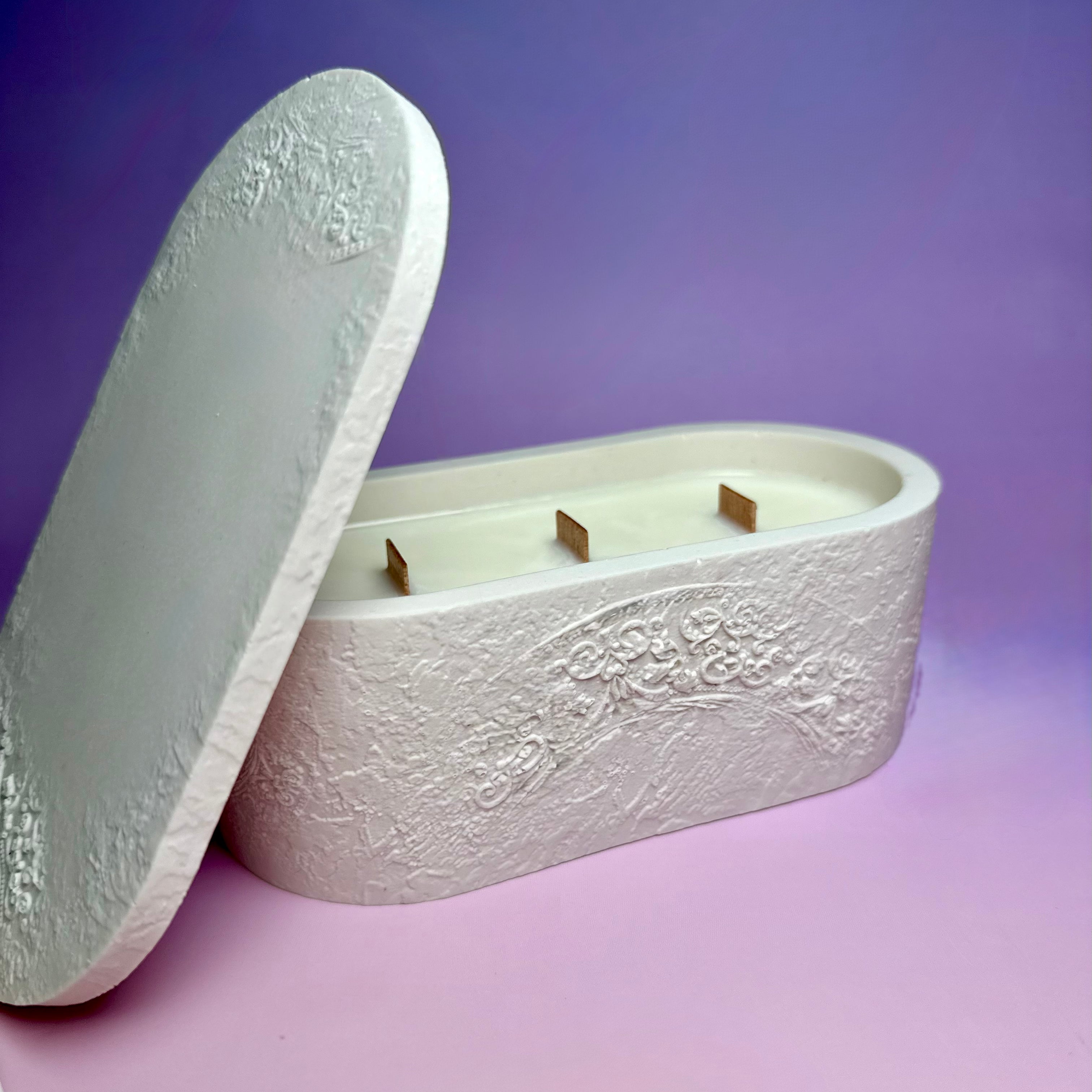 Bespoke triple-wick candle in a handcrafted white Jesmonite vessel, showing the natural soy wax and three wooden wicks.
