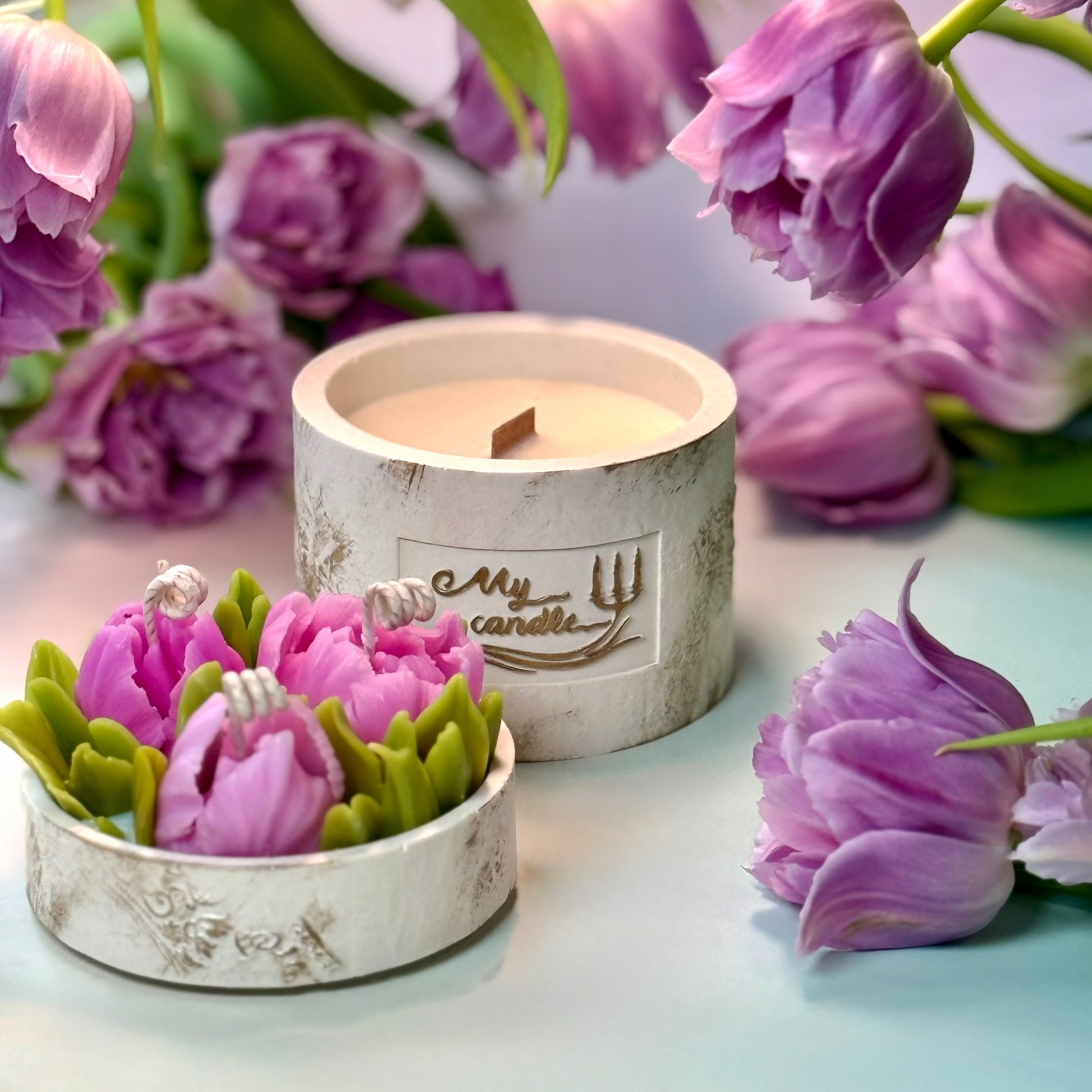 High-angle view of a unique design flower candle vessel featuring handcrafted pink peony tulips inside a white artisan vessel