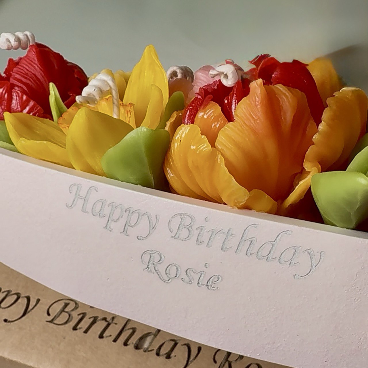 Close-up of personalized text laser engraved on the handcrafted pearl-white candle holder.