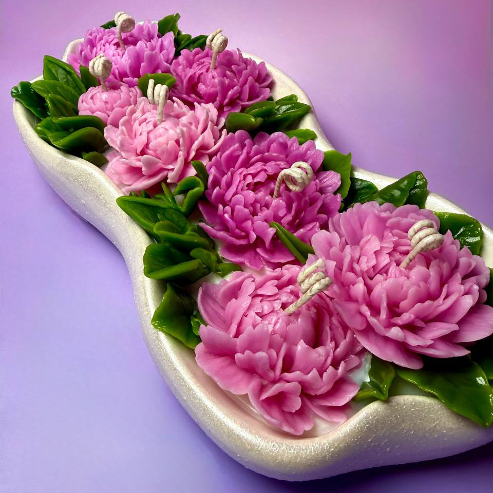 A long perspective shot of the artisanal peony candle arrangement, ideal for table decor.