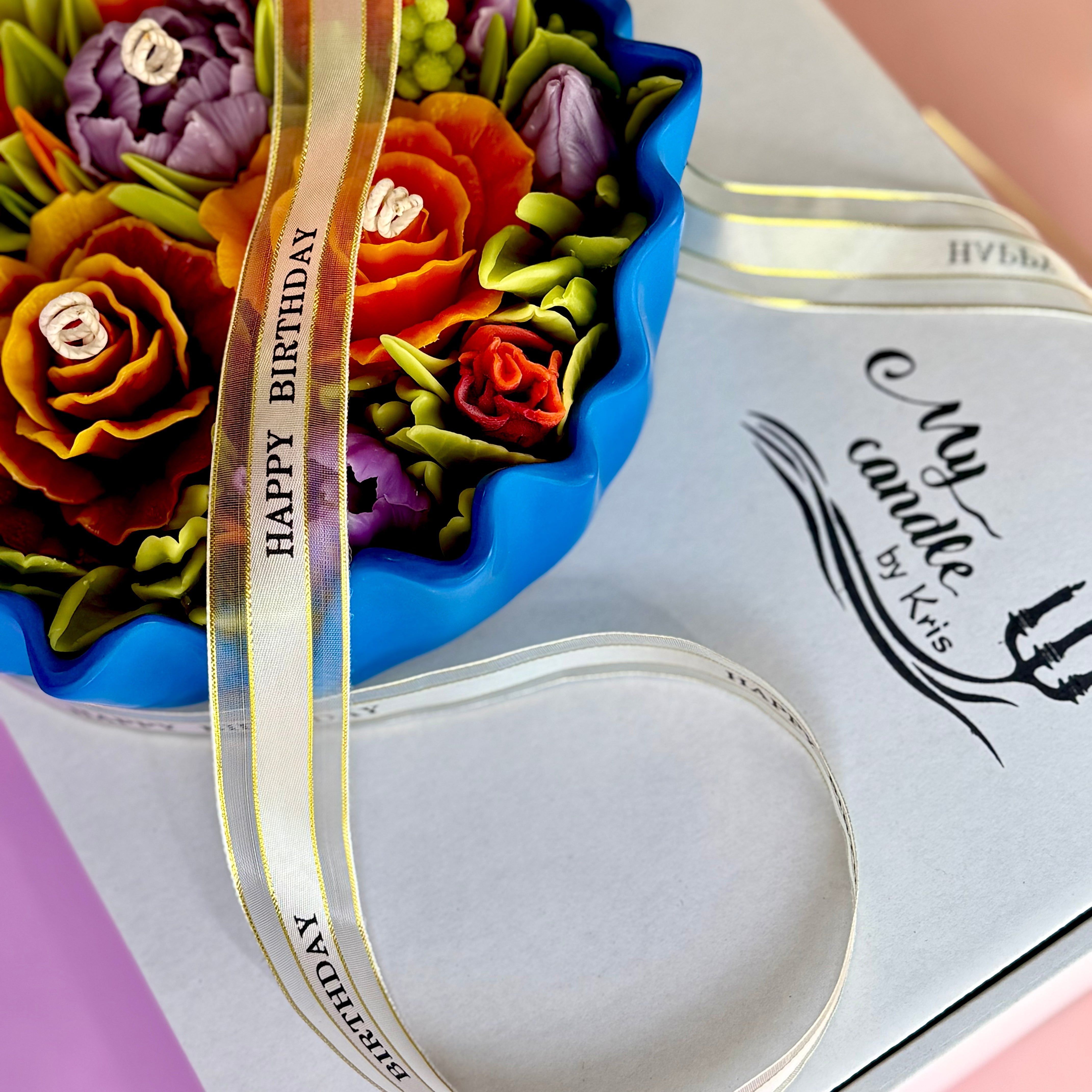 Side view of The Azure Floral Candle nestled in its premium gift packaging with the personalised gold 'Happy Birthday' ribbon and branded box.