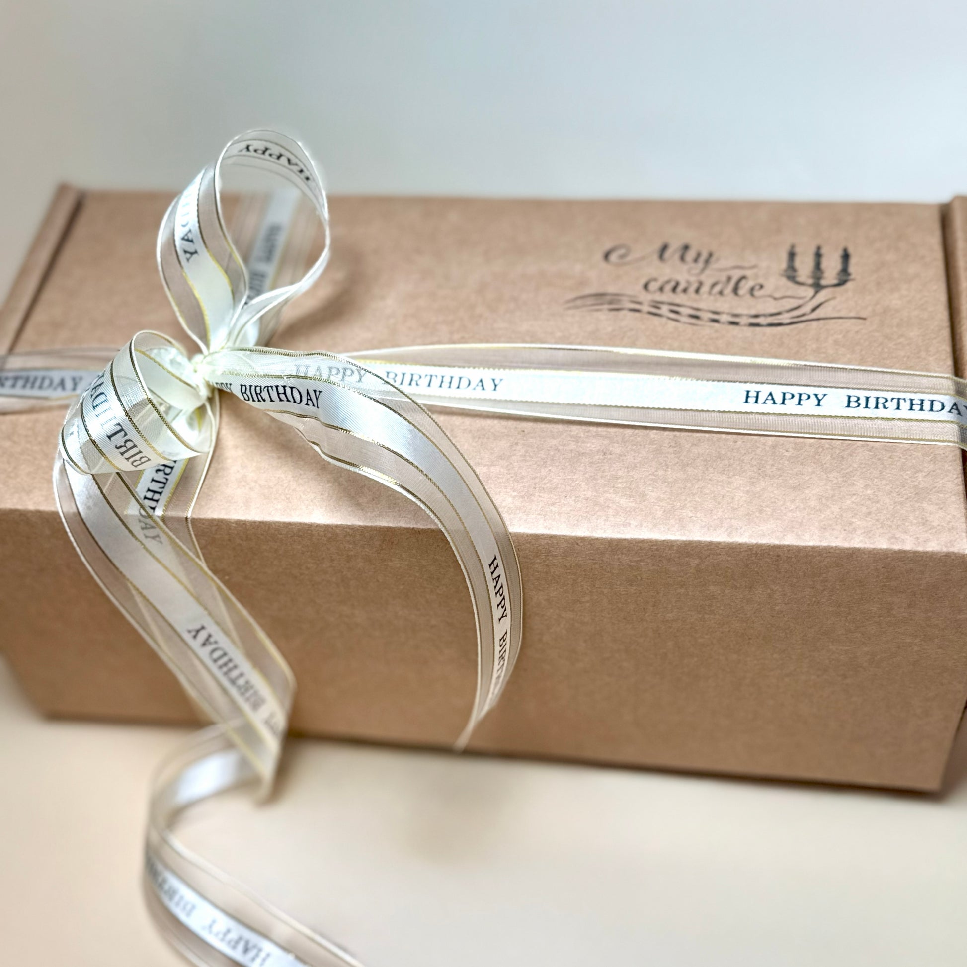 Luxury candle gift box featuring a 'My Candle' brand logo and a white personalised satin ribbon.