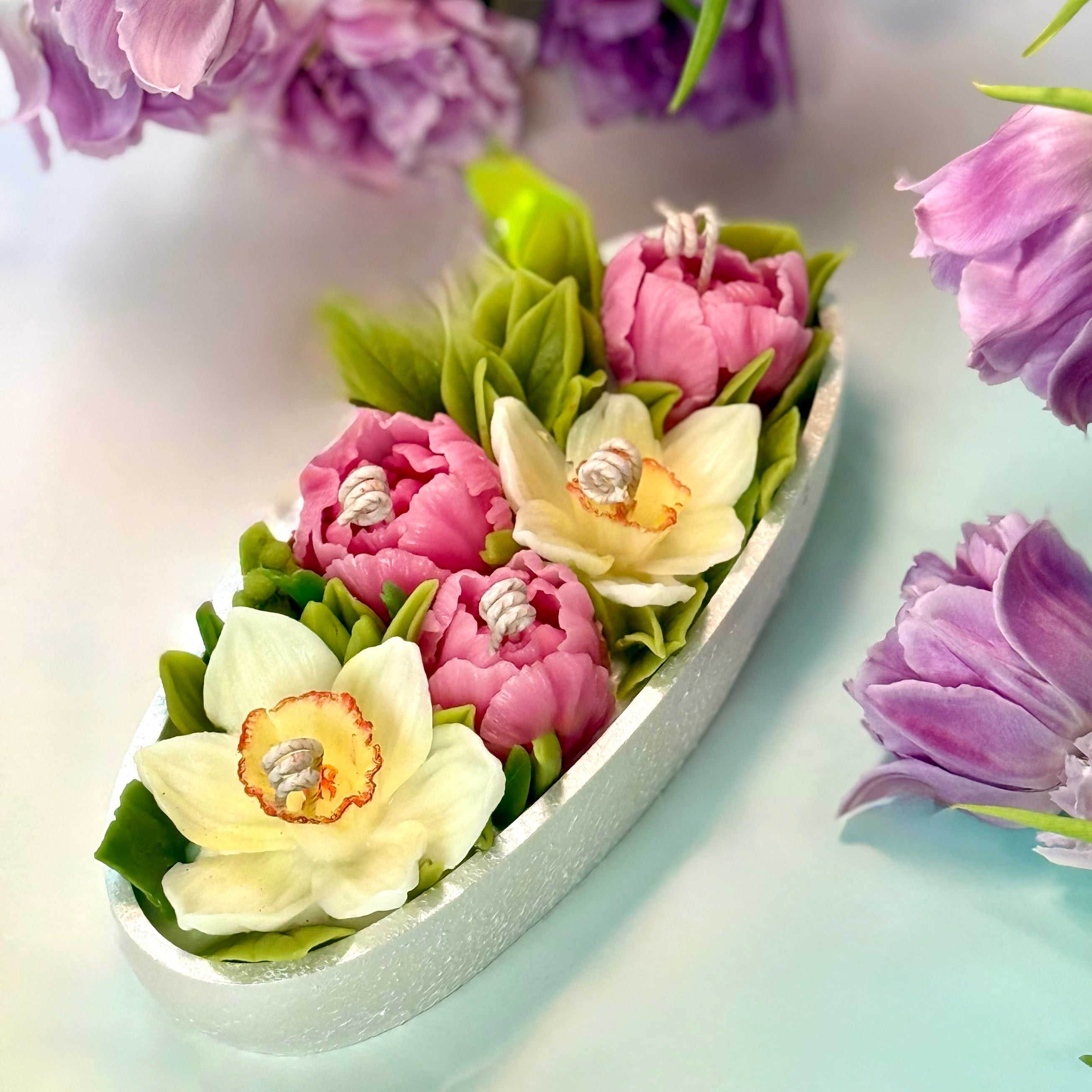 Clear overhead view of a premium botanical centrepiece floral candle showcasing intricate multi-wick design and detailed sculpted beeswax spring blooms with gift box.