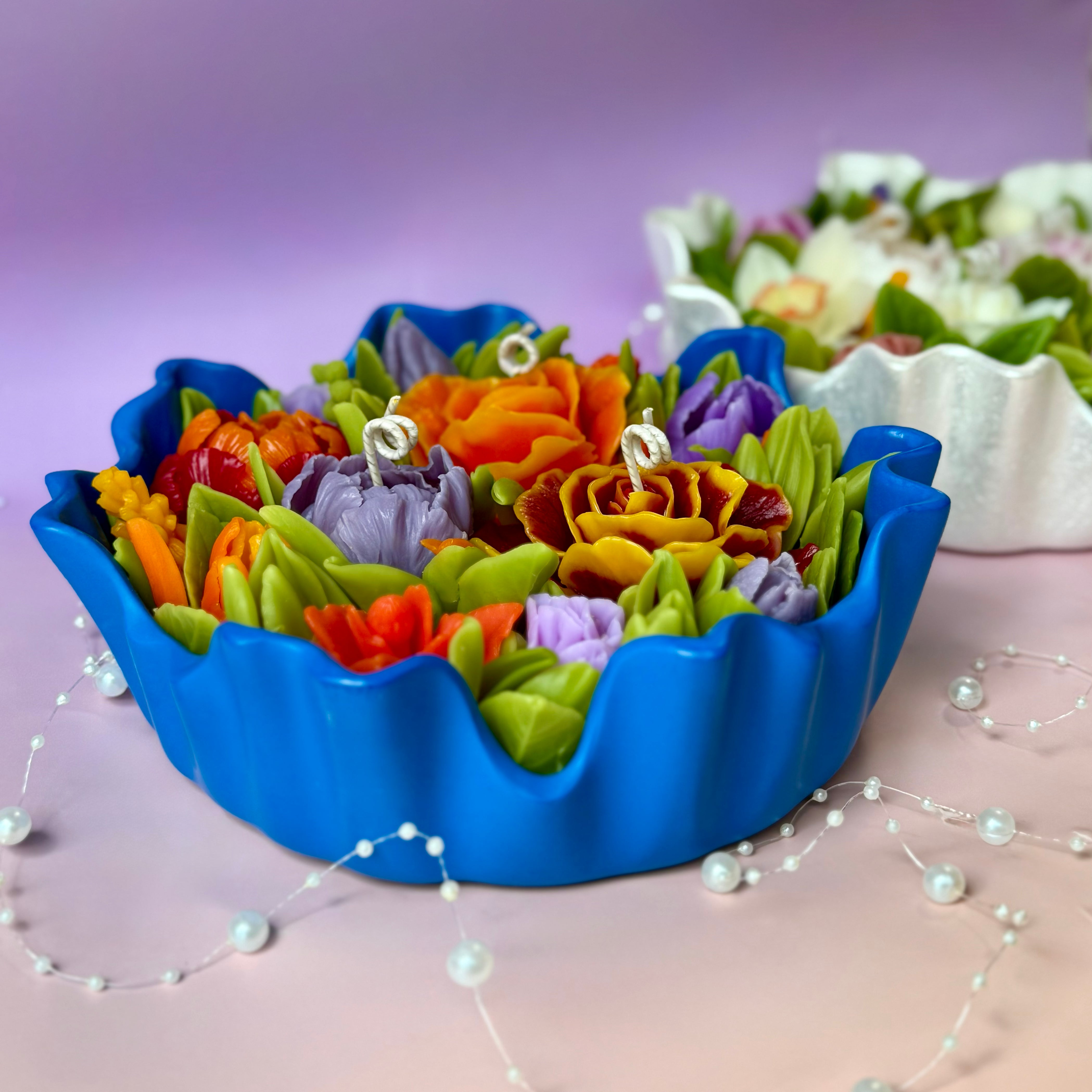 Perspective shot of the large floral candle, showing the scale and vibrant flower details.