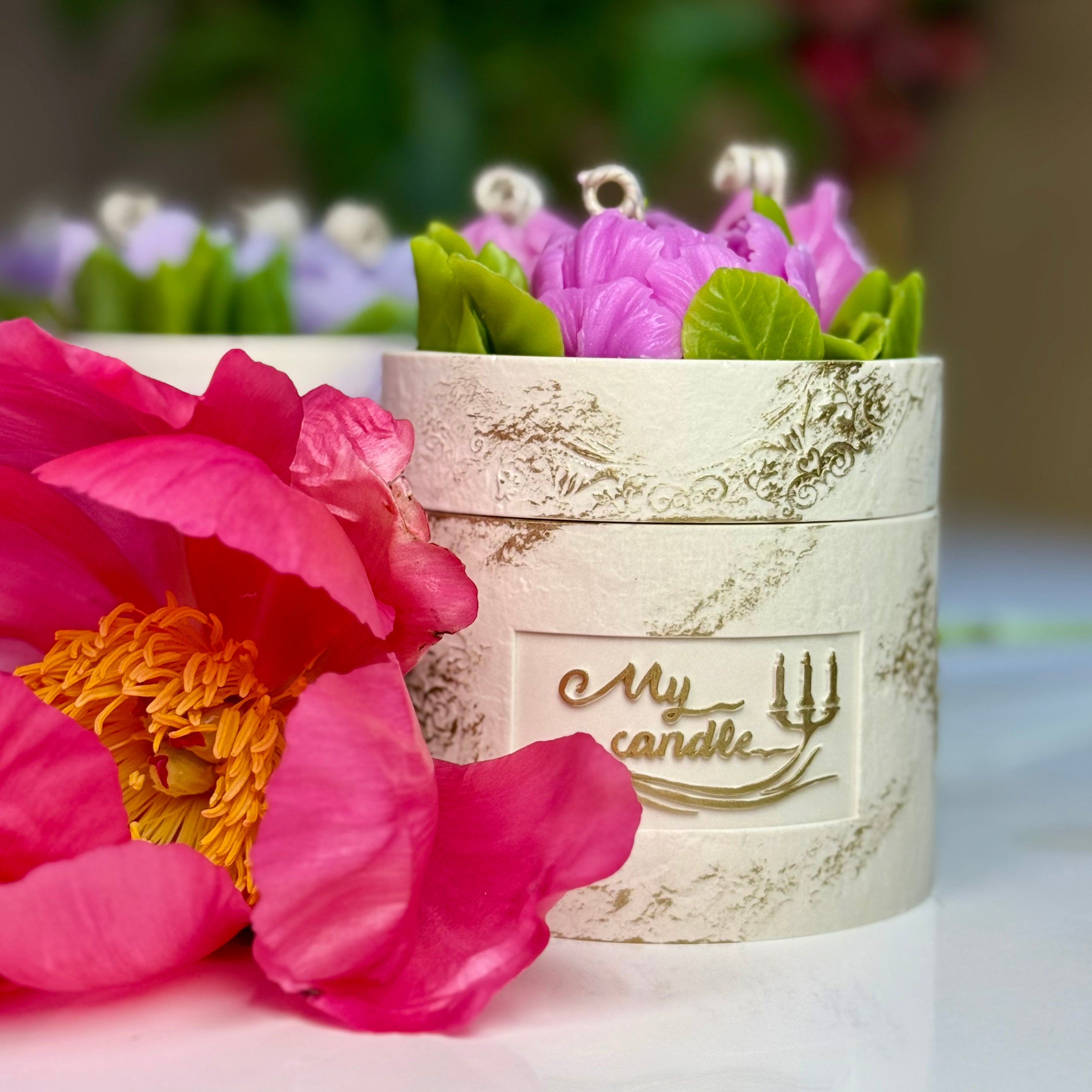 Front view of the artisan stone-textured Jesmonite pot showcasing the elegant gold My Candle by Kris logo on a bespoke flower candle with gift box.