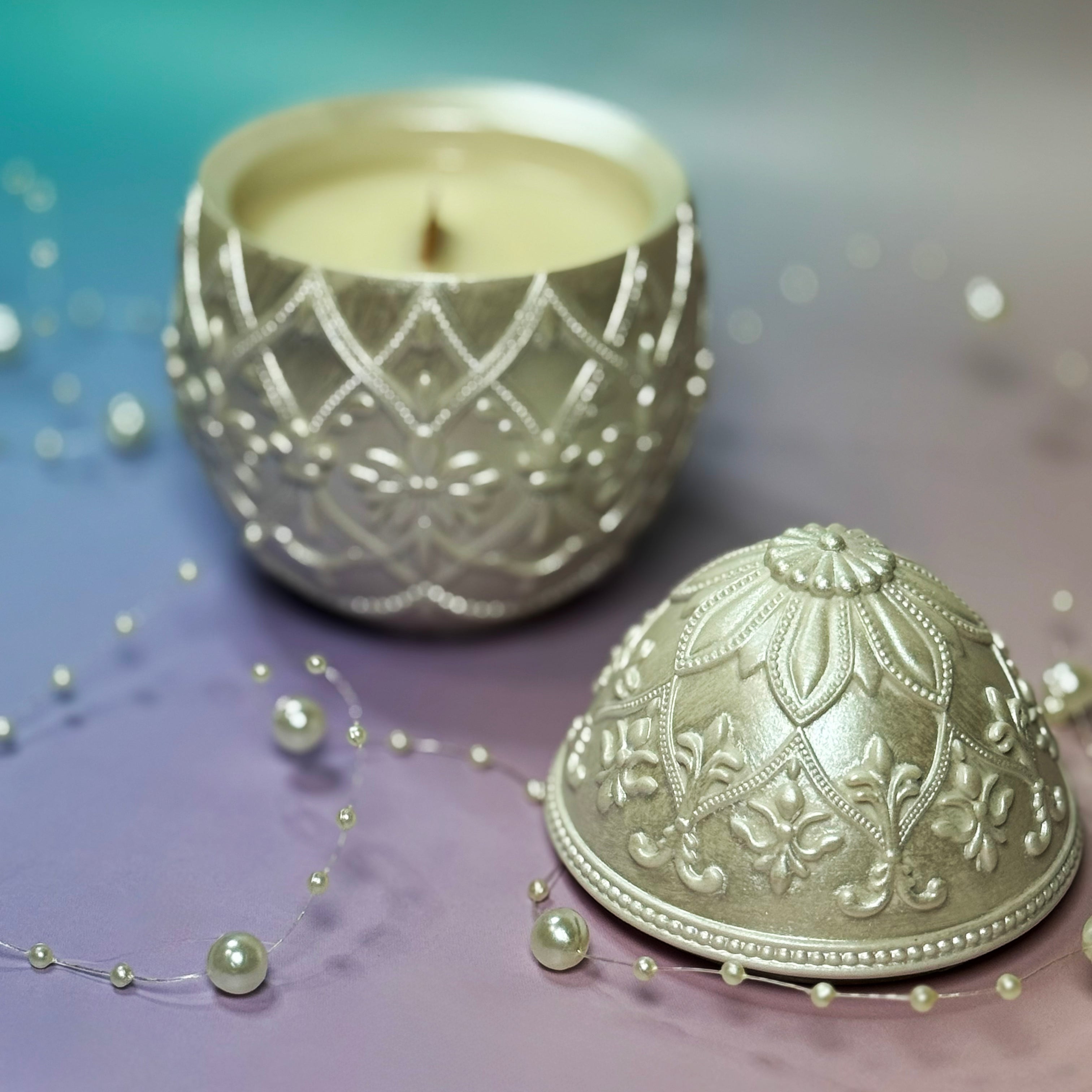 Top angle of an open classic white decorative egg candle container revealing the smooth soy wax and embedded natural wood wick.