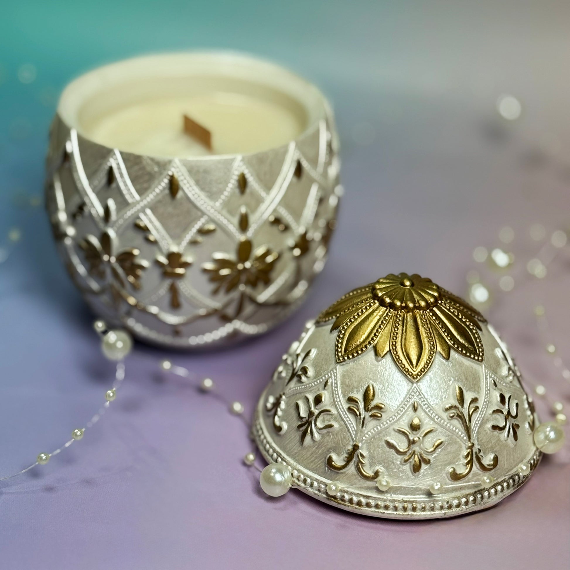 Top view of an open gold-painted Easter egg candle showing the premium soy wax and natural wooden wick inside the handmade Jesmonite container.