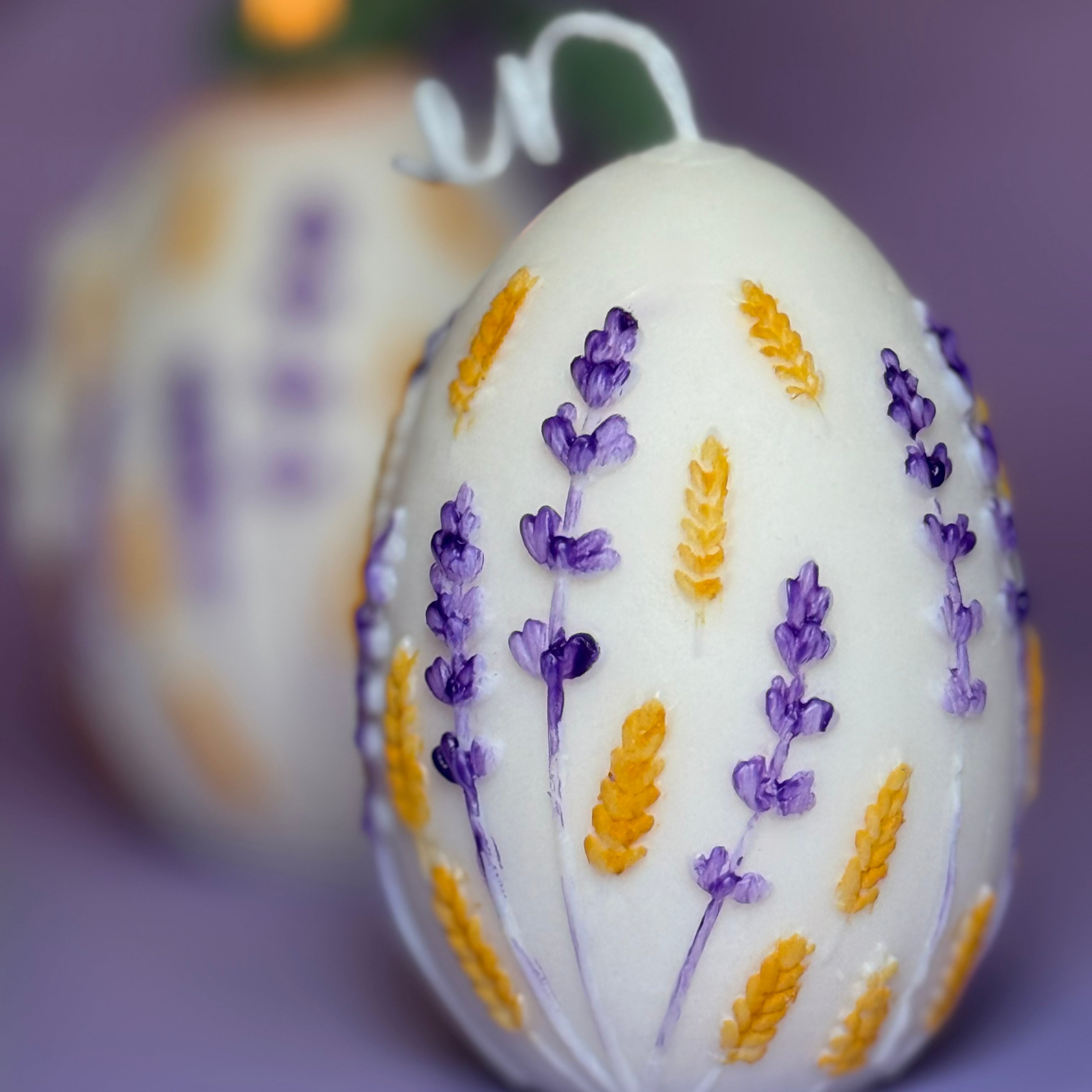 Extreme close-up shot of the hand-painted variant, showcasing the fine brushstrokes of purple and golden-yellow paint on the raised candle ornaments.