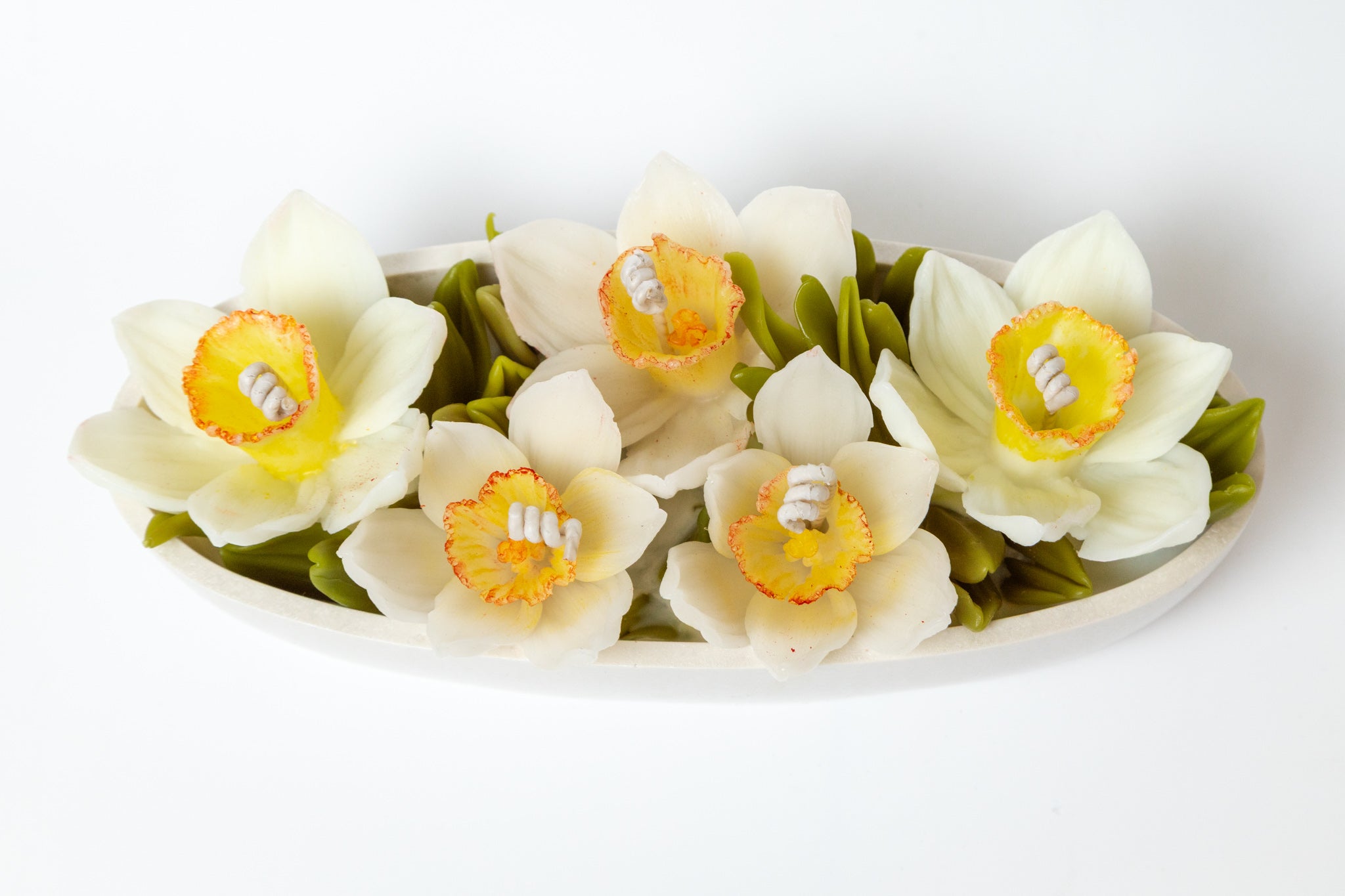 Top down shot of the 5-wick narcissus arrangement in a handcrafted Jesmonite boat-shaped tray.