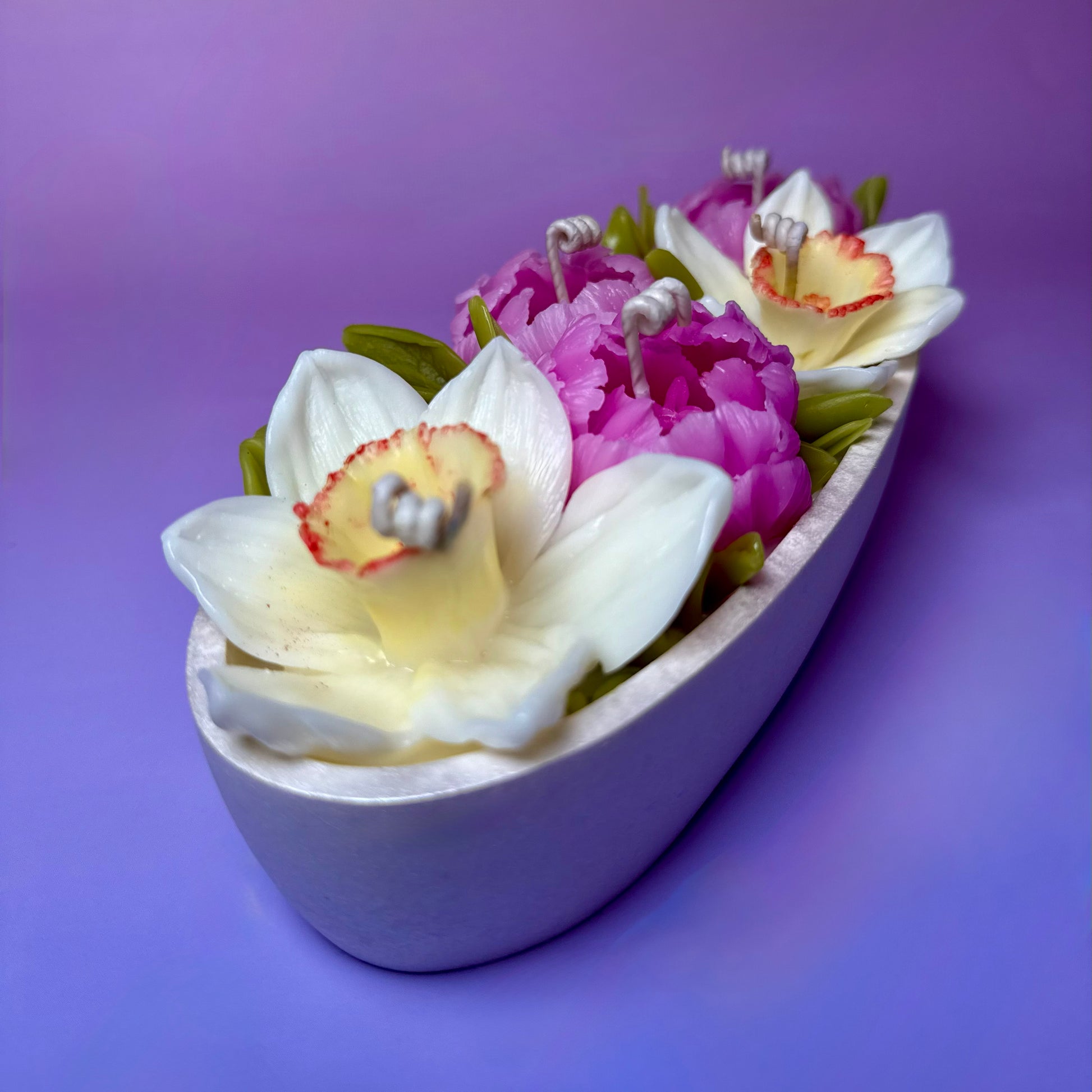 Side view of a blooming floral candle centrepiece highlighting the 5-wick architecture.