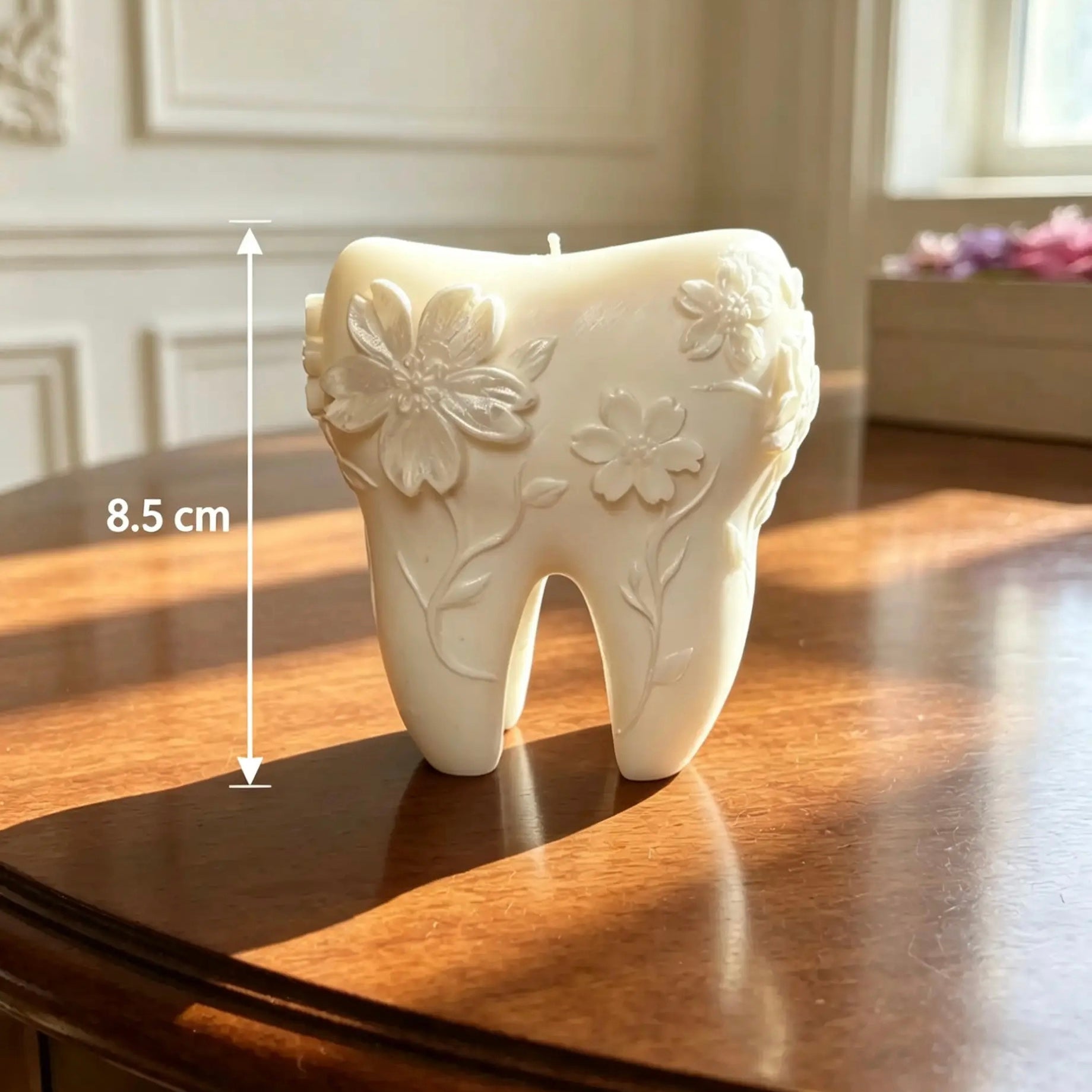 Handcrafted floral tooth shaped candle weighing 410g and standing 8.5 cm tall with intricate raised flower details on a wooden surface.