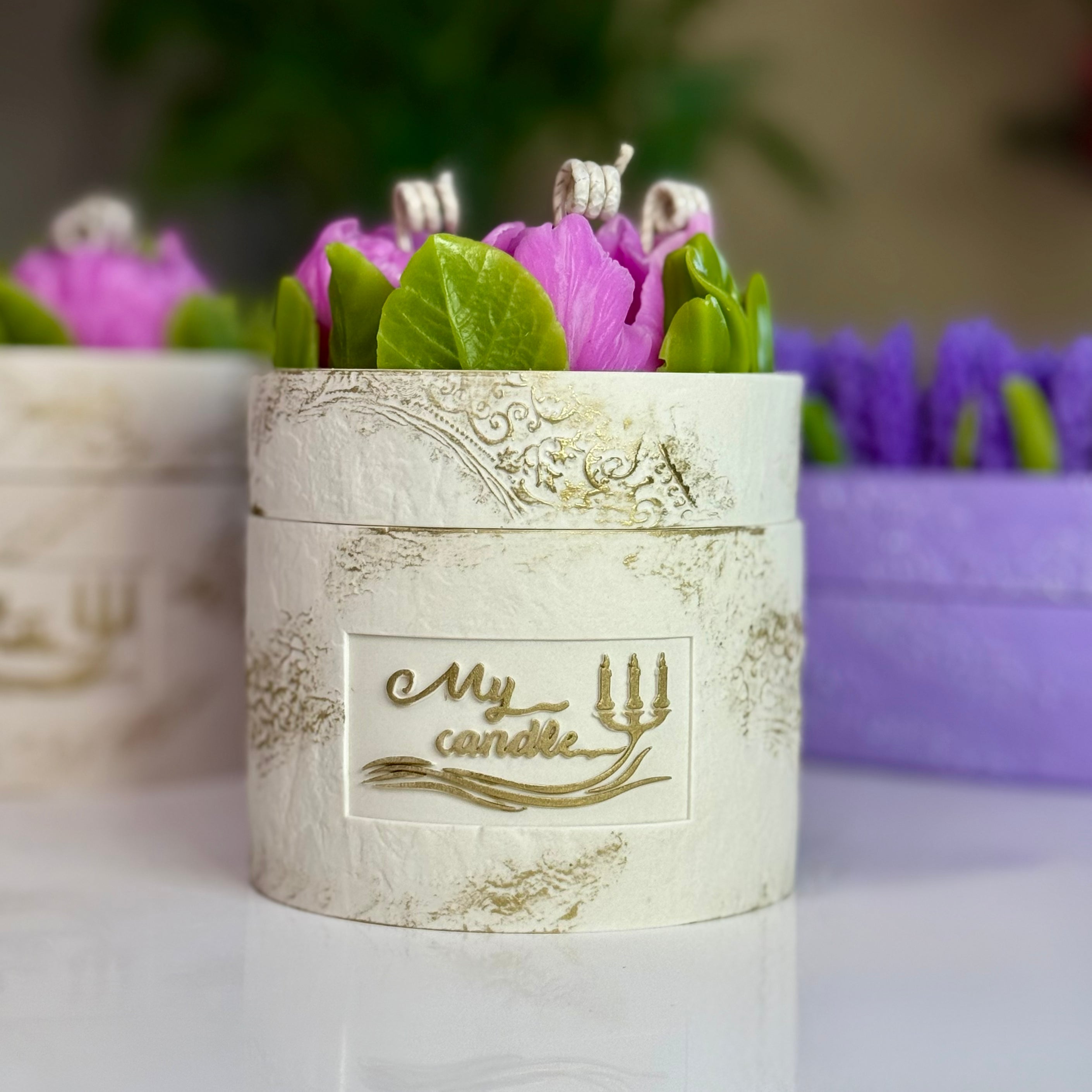Premium centrepiece floral candle paired with a vibrant pink peony flower, accentuating the luxury hand-painted gold relief on the vessel with gift box.