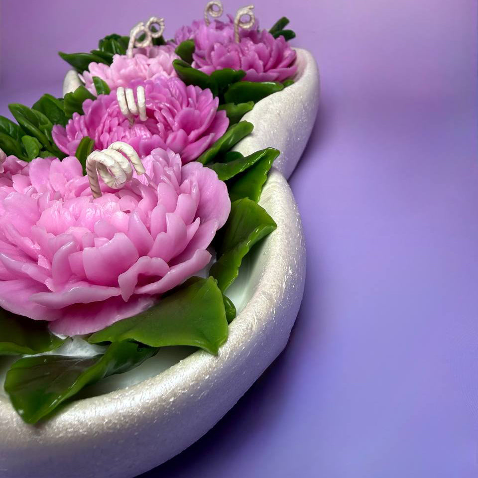 High angle view of the vibrant pink shades and detailed leaves of the beeswax peony garden.