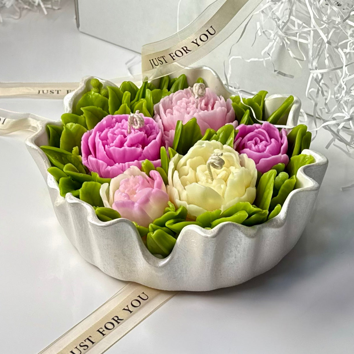 A large 20cm luxury Sarah Bernhardt peony bouquet candle arrangement featuring pink and cream wax sculptures in a handcrafted pearl white Jesmonite scalloped bowl with a satin ribbon.