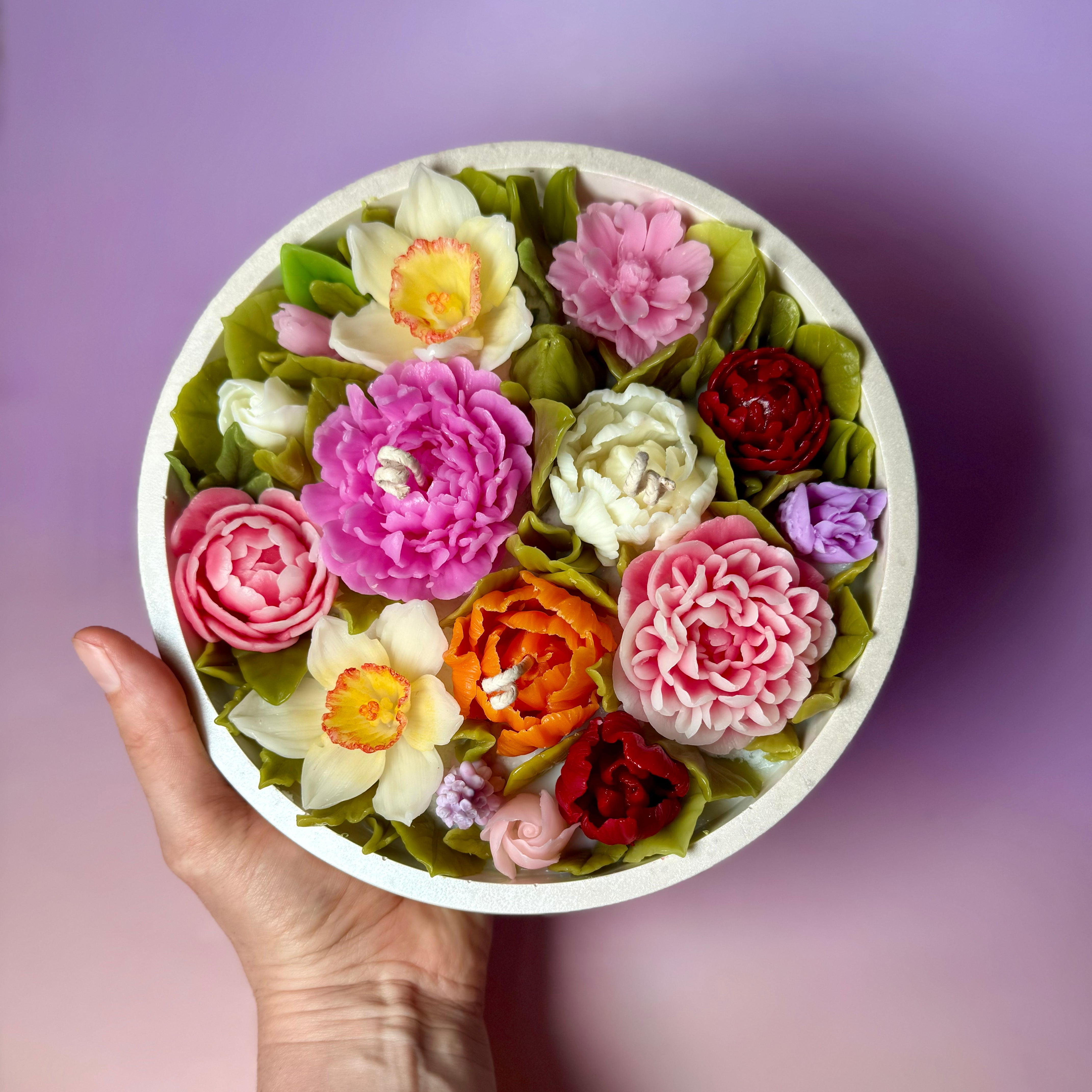 Top-down view of a handcrafted floral candle featuring intricate beeswax flowers, a perfect flower candle statement piece for home decor.