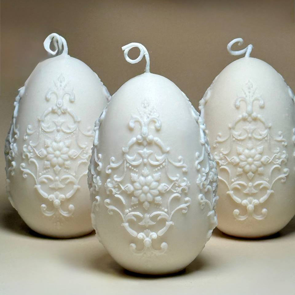 A set of three elegant Baroque style Easter egg candles arranged together as a luxury spring centrepiece for Easter home decor.