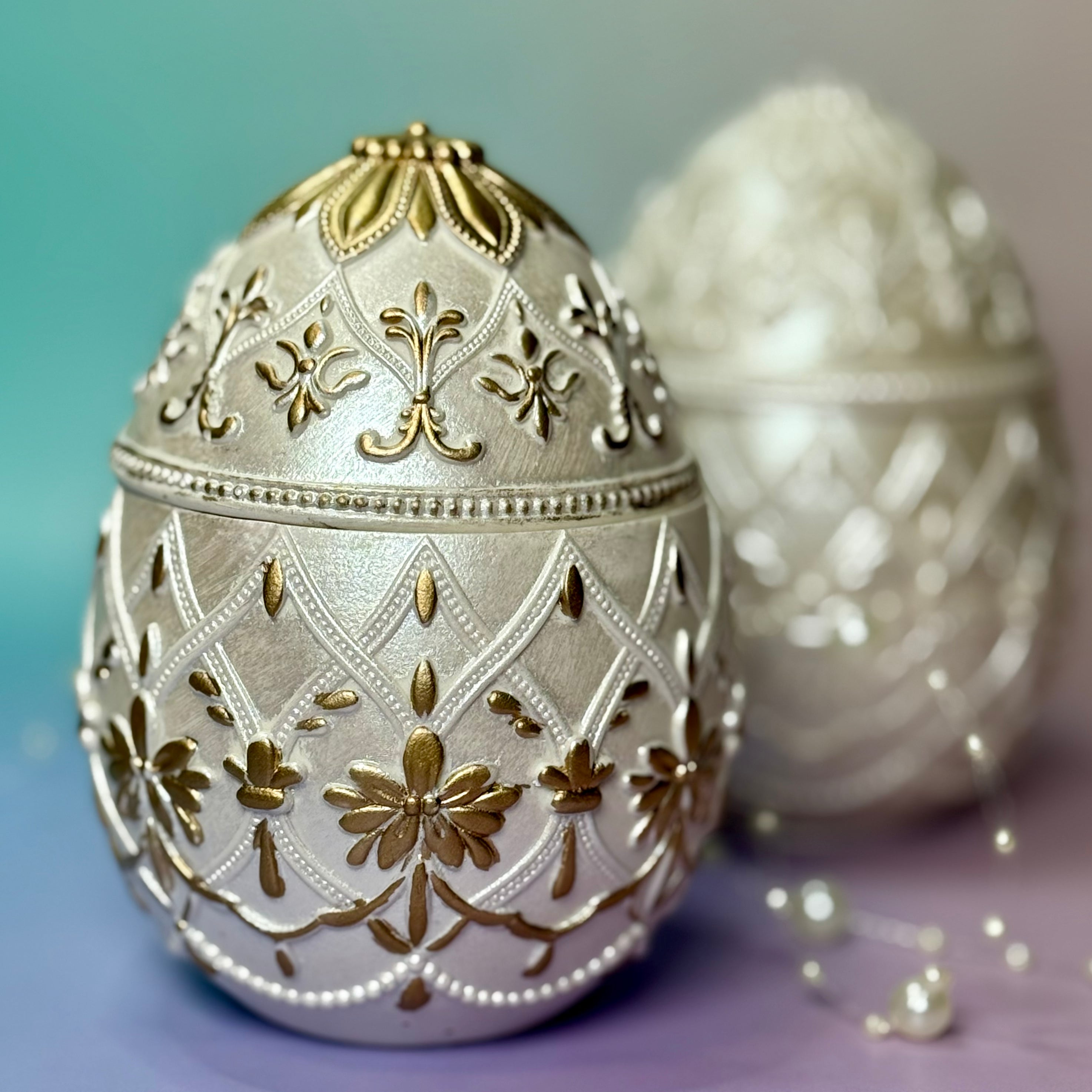 Front view of the hand-painted gold baroque style Easter egg candle made from Jesmonite, showcasing the imperial relief design for luxury spring home decor.