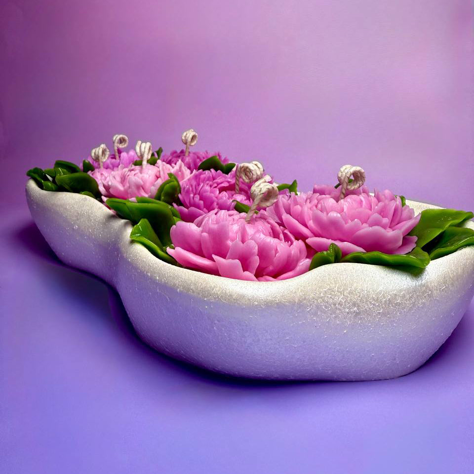 Low angle view highlighting the shimmering hand-painted finish of the Jesmonite boat tray.