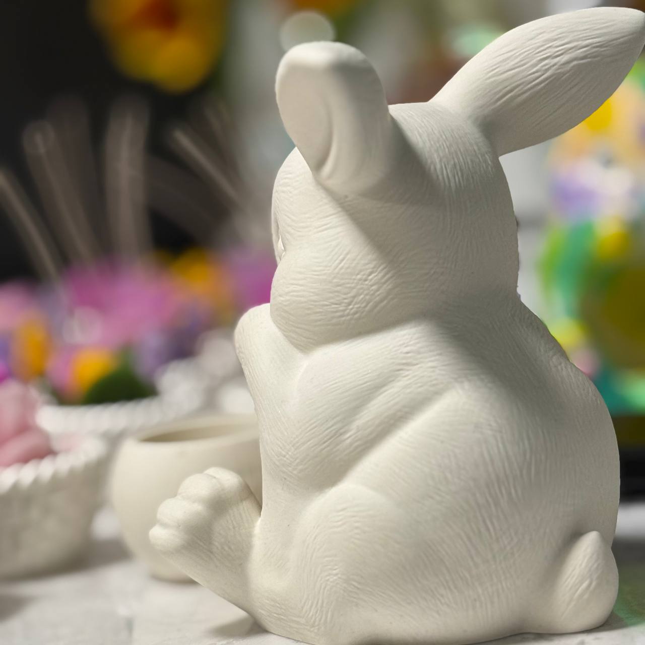 The back view of a minimalist white Jesmonite bunny figurine, highlighting the detailed fur texture and shape, styled as unscented aesthetic decor for Easter.