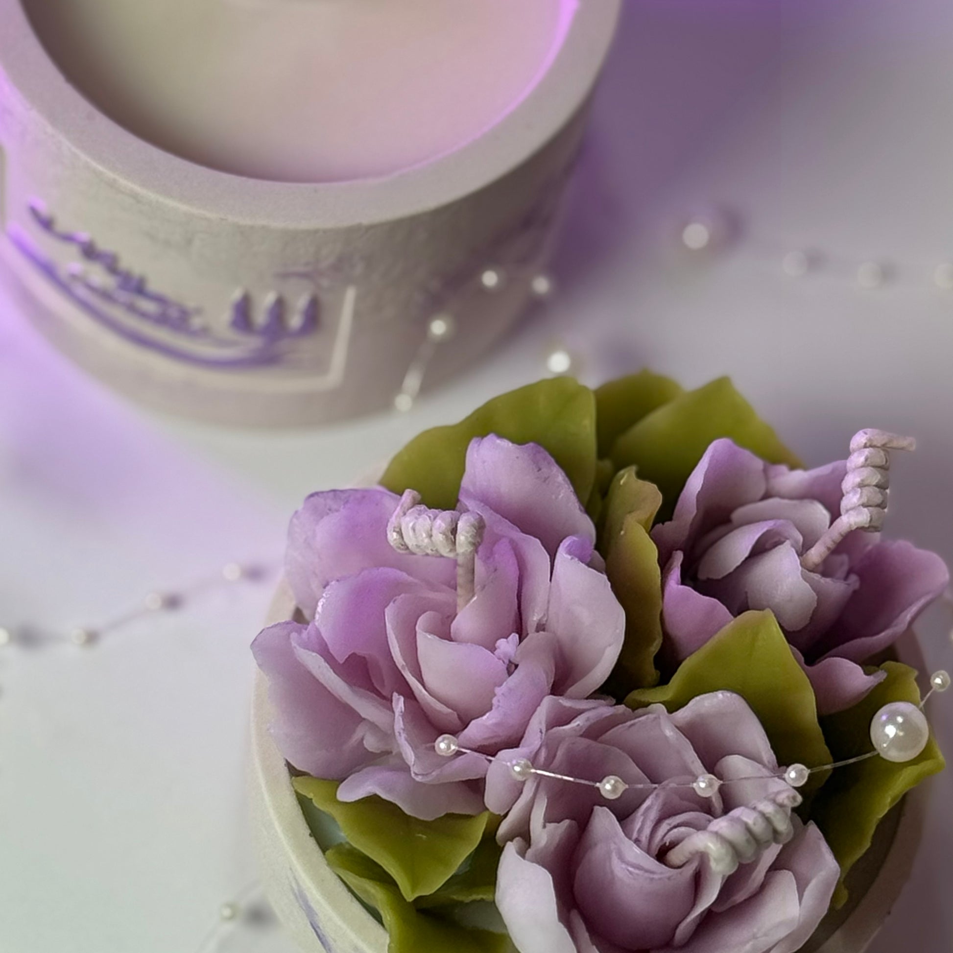 Showcase of the two-part modular candle design featuring a soy wax base and beeswax floral topper.