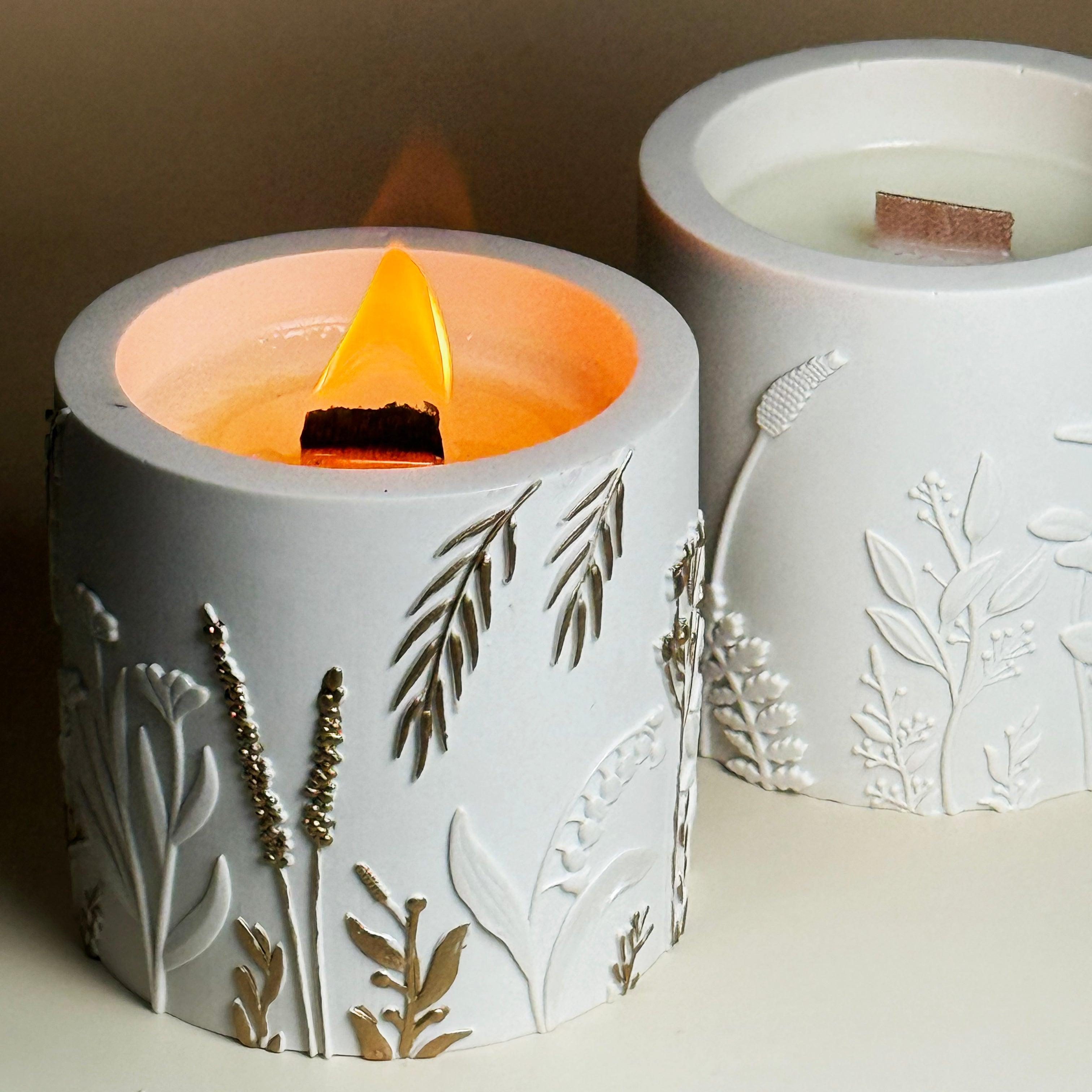 Direct top down view of an open gold-detailed botanical candle container showing the premium hand-poured soy wax inside the handmade Jesmonite jar.