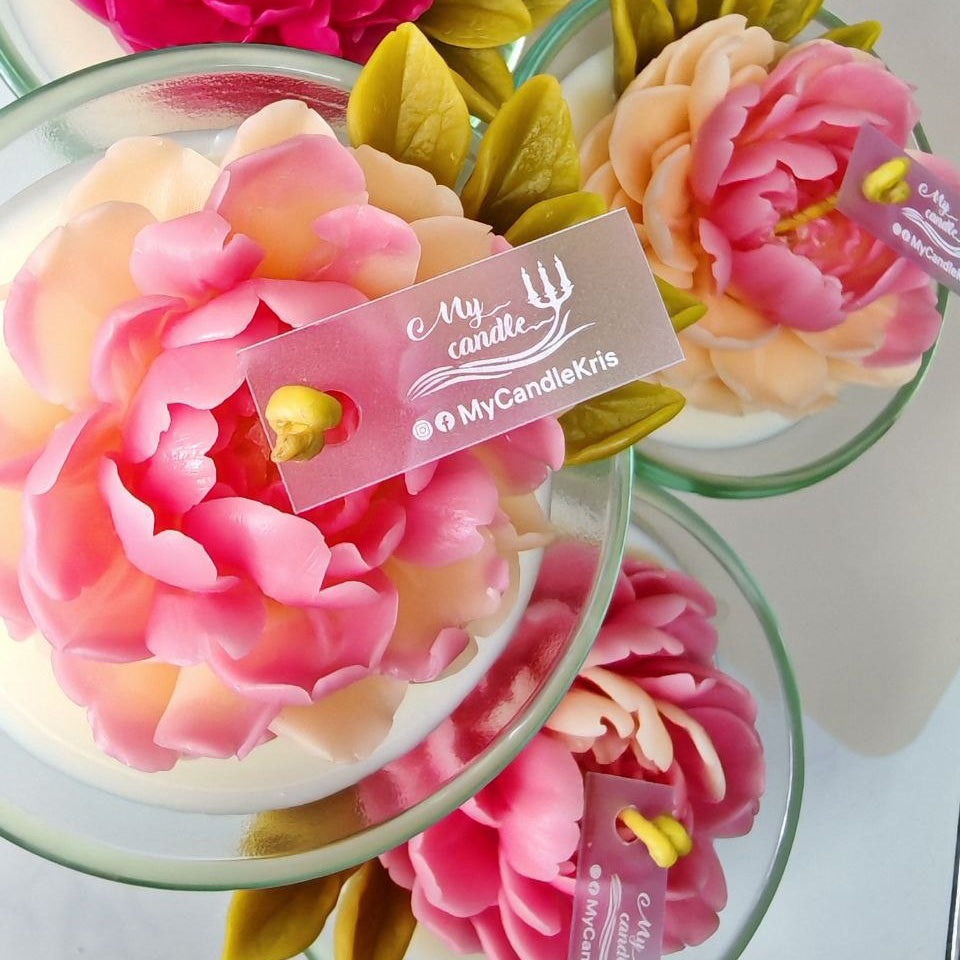 A group of luxury Peony Bloom sculptural candles in various shades of pink and peach.