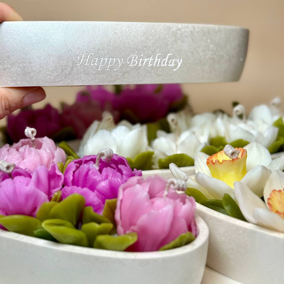 Main photo showing the narcissus flower candle with custom laser engraving on the pearl-white vessel.
