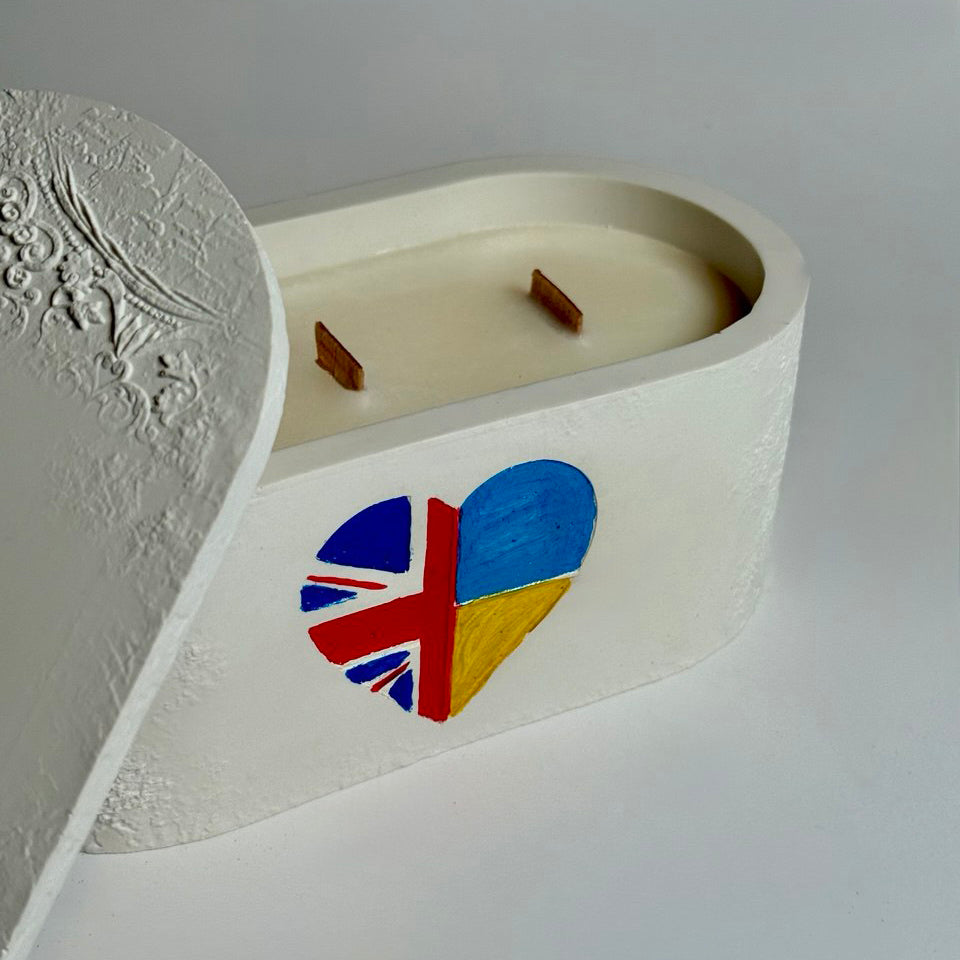 Personalised triple-wick candle in a white Jesmonite pot featuring a hand-painted heart with UK and Ukraine flags as a symbol of gratitude and solidarity.
Bespoke Unity Candles showcasing different flag combinations (Ukraine-Slovakia and UK-Ukraine), celebrating international friendship and support in the UK.
Personalised keepsake candle with a Scotland-Ukraine flag heart, demonstrating the "any two flags" customisation for a unique gratitude gift UK.