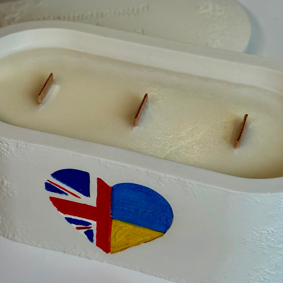 Personalised triple-wick candle in a white Jesmonite pot featuring a hand-painted heart with UK and Ukraine flags as a symbol of gratitude and solidarity.
Bespoke Unity Candles showcasing different flag combinations (Ukraine-Slovakia and UK-Ukraine), celebrating international friendship and support in the UK.
Personalised keepsake candle with a Scotland-Ukraine flag heart, demonstrating the "any two flags" customisation for a unique gratitude gift UK.