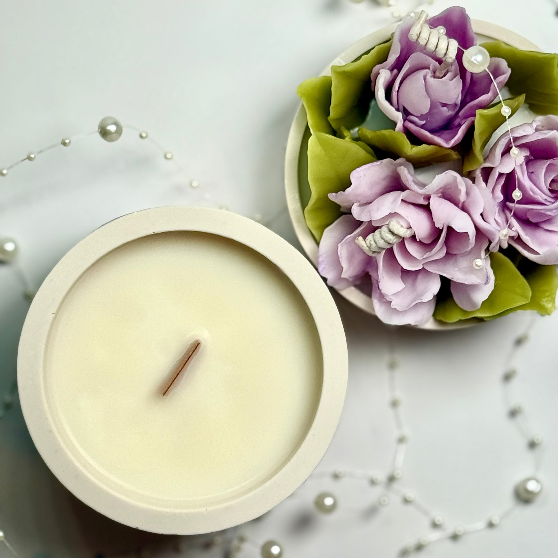 Bird's-eye view of the natural soy wax base with a sustainable wooden wick and floral lid.